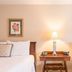 Brick Street Inn in Zionsville: twin guest beds with framed floral art and a lit bedside lamp