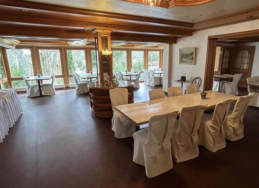 Gästehaus am Kurpark VS dining room with set tables and large windows in Villingen-Schwenningen