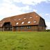 Premier Inn Milton Keynes South in Milton Keynes, windmill and farmhouse-style hotel exterior on grassy grounds