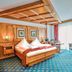 Schloss Hotel Holzrichter room in Nachrodt-Wiblingwerde with wooden bed, desk and large window