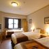 Hotel Monterey Nagasaki in Nagasaki guest room with three twin beds and window seating