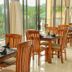 Oak Ray Heritage Hotel in Kandy restaurant seating with floor-to-ceiling windows and lush hillside views