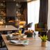 De La Pommeraie Le Mans lounge with tables, chairs, fireplace and large window