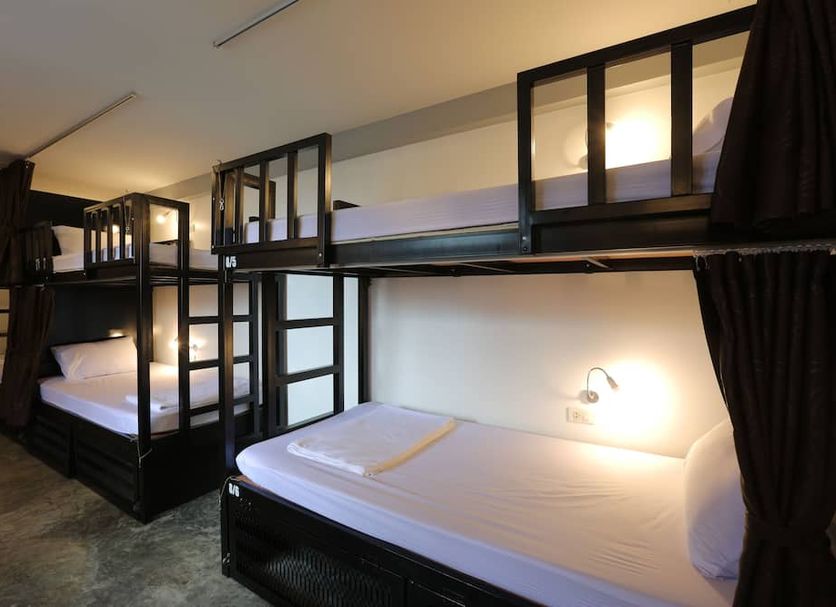 Balcony Party Hostel - Adult 18+ in Krabi bunk room with black-framed twin beds and privacy curtains