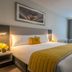 Maldron Hotel Dublin Airport room with king bed, desk, chair and window seating in Dublin