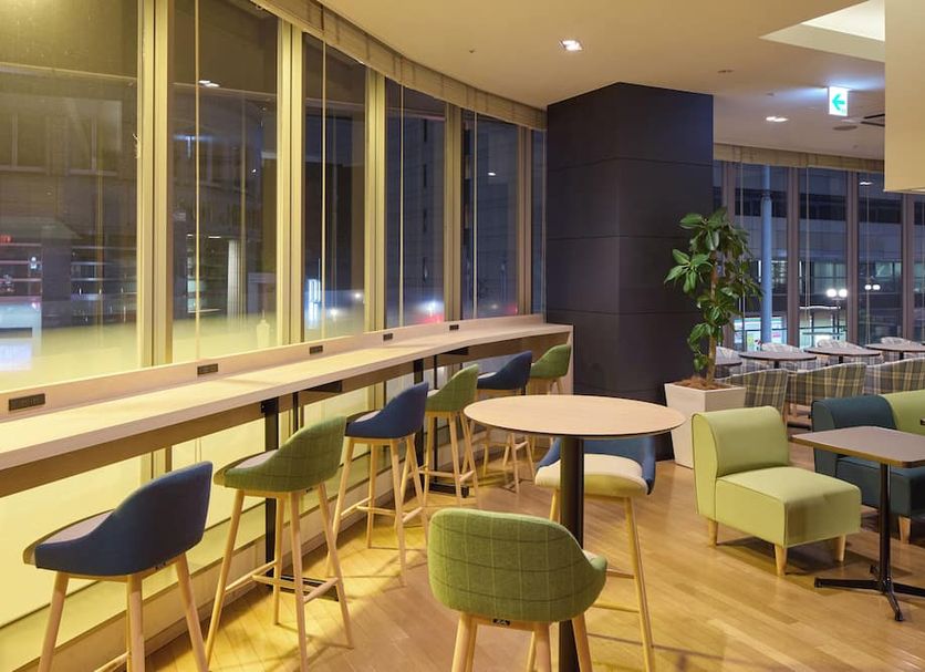 Kobe Motomachi Tokyu Rei Hotel lounge with bar seating, tables, and city-view windows in Kobe