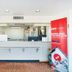 Budgetlodge in Oklahoma City lobby with reception desk, potted plants and OYO app sign