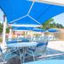 Berkley Lake Townhomes in Kissimmee with blue shade canopies over poolside tables beside the swimming pool