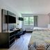 Studio 6-Jacksonville, FL - Baymeadows room with two beds, desk, TV and window in Jacksonville
