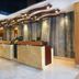 Meshal Hotel & Spa in Manama lobby with front desk, warm lighting, and abstract sculpture