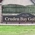 Cruden Bay Golf Club sign near By The Bay in Peterhead, beside a grassy lawn