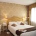Cà Furlan Venice hotel room with double bed, floral wallpaper, and window light