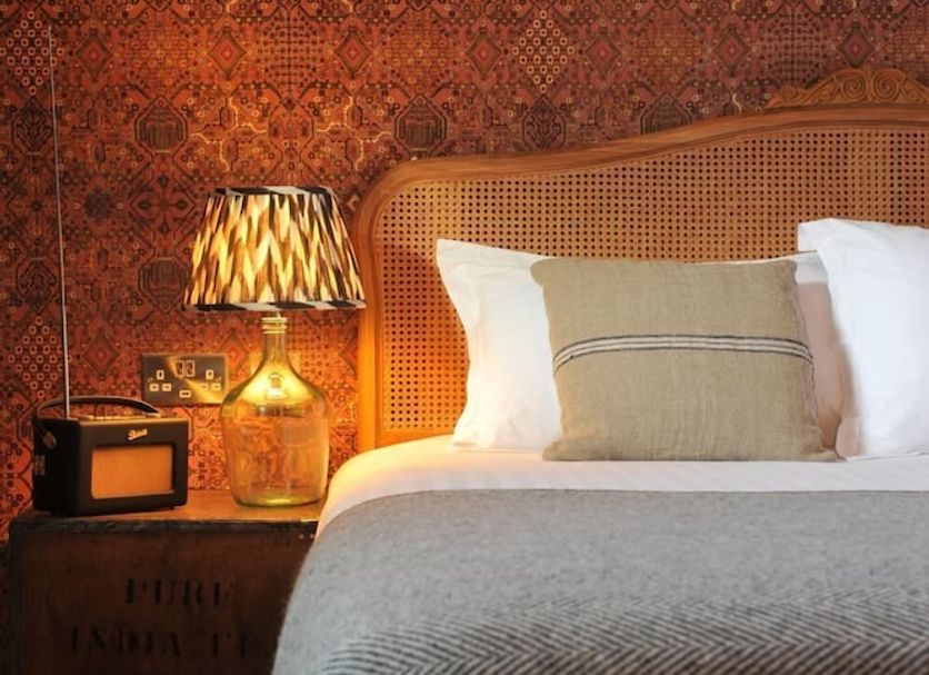 The Driftwood in Sligo guest room with patterned wall, bedside lamp, and neatly made bed