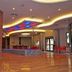 Gazelle Resort & Spa Karacasu lobby with colorful ceiling lights, polished wood floor and seating