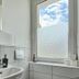 Apartments Fichtelberger Blick, Oberwiesenthal bathroom sink with tiled wall and frosted window