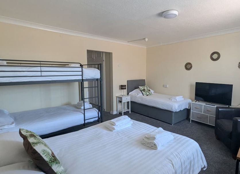 The Bell, Bury St. Edmunds: family room with bunk bed, twin beds, TV and armchair