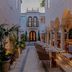 Donatella Boutique Hotel, Miami Beach: narrow courtyard walkway with arched seating area and palm plants