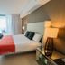 Lyfe Resort And Residences Hollywood guest room with king bed, balcony view, TV and seating area