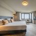 Leonardo Hotel Ijmuiden Seaport Beach room with sea view, desk, TV and twin beds in IJmuiden