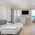 Georgalas Sun Beach Resort room with sea view, balcony chairs, sofa bed and dining table in Nea Kallikratia