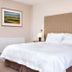 The Lodge At Craigielaw room in Gullane with king bed, bedside lamps and framed wall art