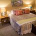 Fairfield Manor Bed and Breakfast in Shreveport, bedroom with a neatly made bed and bedside lamps