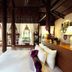 Ho Tram Beach Boutique Resort & Spa in Ba Ria: airy suite with king bed, wood beams and garden views