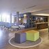 Novotel Campo Grande lobby with check-in desk, lounge seating, and colorful cube ottomans