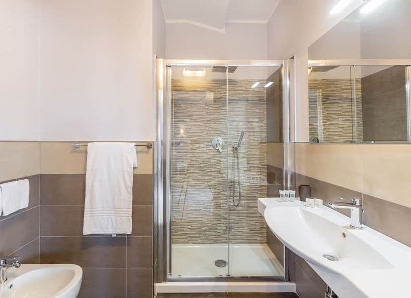 Hotel Rosa Dei Venti in Castelsardo: modern bathroom with glass shower, sink, toilet and towel rack