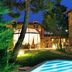 Hotel Boutique Real Casona de las Amas in Azofra: lit outdoor pool and garden courtyard at night