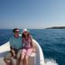 Oasis Scaleta Hotel in Skaleta: couple sitting on a boat with blue sea and coastline view