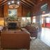 Cumberland Falls State Resort Park lobby in Corbin with leather sofas, stone fireplace, and wood beam ceiling