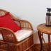 Rio Arriba Suites Apartments y Resto in Bella Vista: wicker chair with red pillow beside a small table and thermos