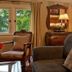 Beaufort House Inn Asheville guest room with upholstered sofa, armchair, windows and wooden dresser