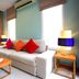 Apsara Beachfront Resort And Villa in Takua Pa living room with sofa, coffee table, lamps and garden view