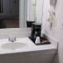 Cassville Budget Inn bathroom vanity with sink, mirror and coffee maker in Cassville