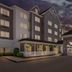 Country Inn & Suites by Radisson Princeton, WV exterior with covered entrance at dusk
