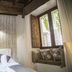 Do-Do Navona Suites in Rome: cozy room with bed, window seat, and open window to city view