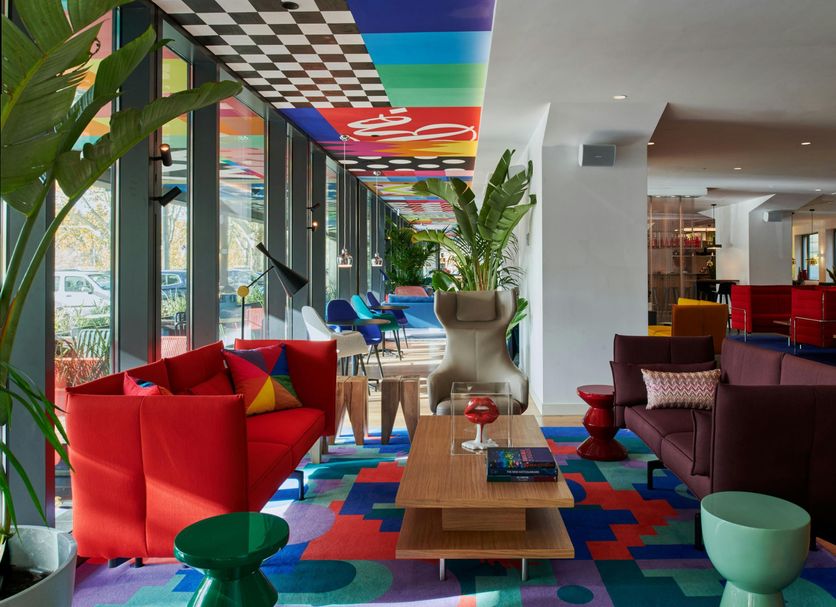 citizenM Rome Isola Tiberina lounge with colorful seating and patterned ceiling in Rome