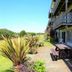 The Polynesian Resort in Ocean Shores, patio beside lawn with picnic table and garden plants
