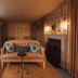 No 15 by GuestHouse, Bath lounge with velvet sofa, fireplace, backlit bar shelves and warm lighting