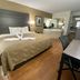 Quality Inn Branson - Hwy 76 Central guest room with king bed, desk, and vanity area in Branson