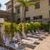 Hampton Inn & Suites Ontario courtyard pool deck with lounge chairs and palm trees