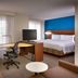 Residence Inn by Marriott Salt Lake City-West Jordan suite with king bed, desk, TV, and blue accent wall