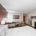 Red Roof Inn Bristol guest room with king bed, desk, TV, mini fridge and wardrobe