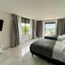 Condo in Ocean Front Resort, Cancún: bedroom with two beds and ocean-view balcony doors