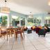 Deltour Hotel Le Puy En Velay lounge with dining table, seating area and garden views in Le-Puy-en-Velay