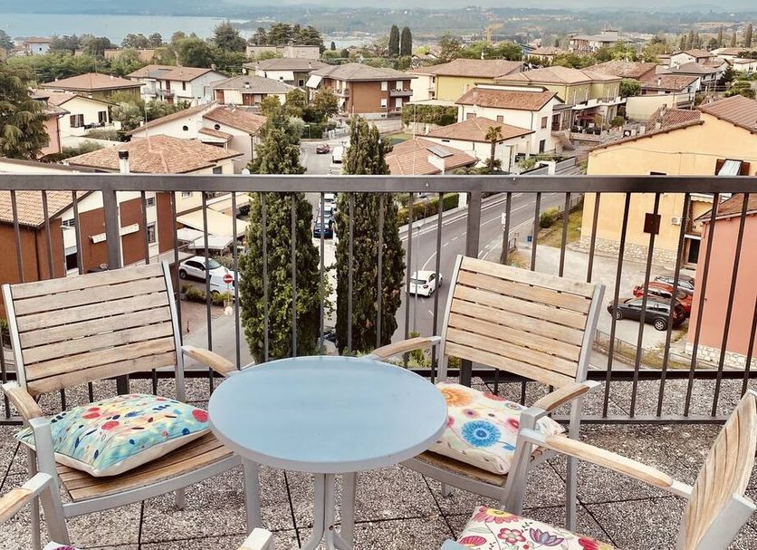 Green Park Hotel in Peschiera del Garda balcony with table, chairs and lake view over rooftops