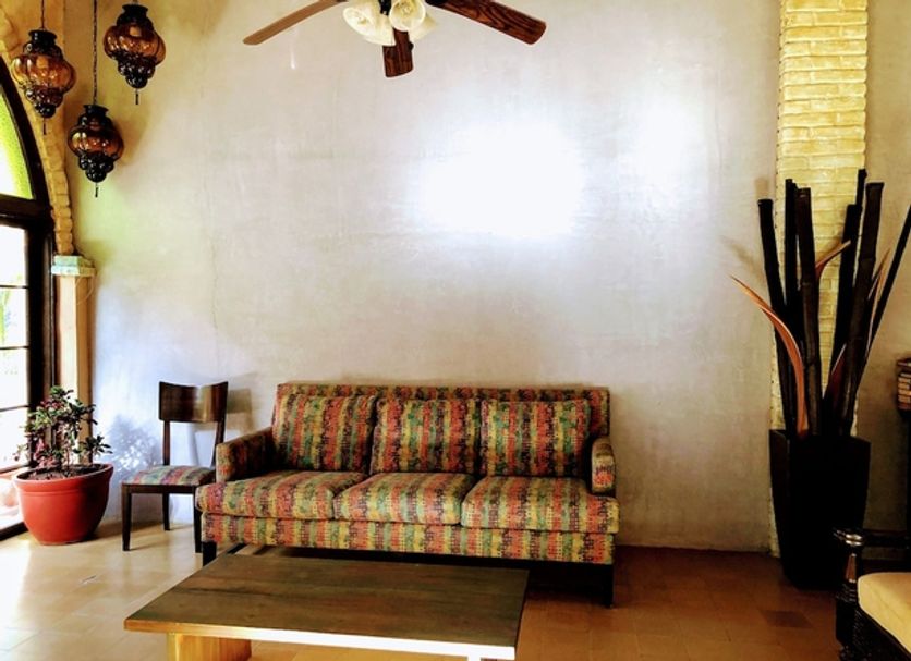 Mar de Cortez in Cabo San Lucas lobby with patterned sofa, coffee table, hanging lanterns and ceiling fan