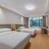 Tizi Hostel in Shanghai guest room with two beds and a large window view